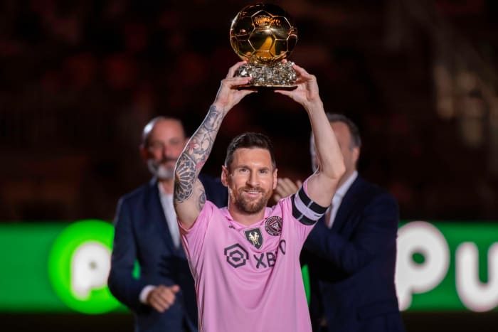 Inter Miami captain Lionel Messi pictured lifting his Ballon d'Or trophy at a celebration event at DRV PNK Stadium in November 2023